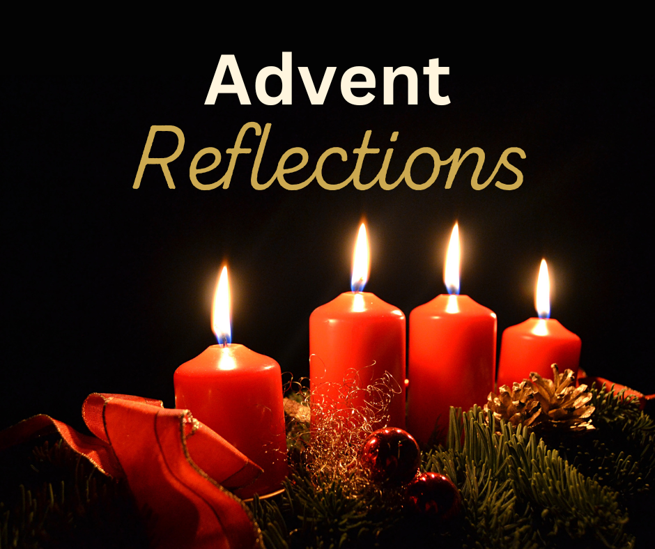 lighted advent candles on a dark background